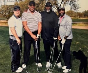 Eric Swann at a charity golf tournament with three other players.